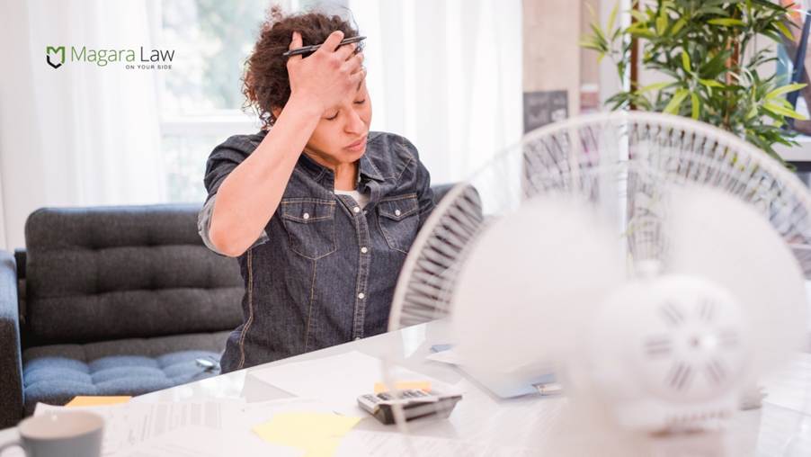 A woman at work experiencing menopause, which is affecting her mental health.