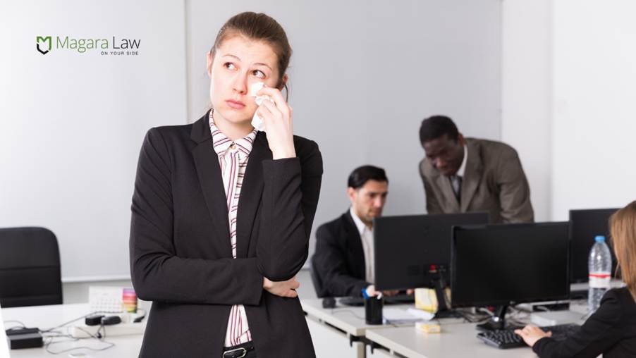 A woman crying amid out of control workplace banter and unlawful harassment.