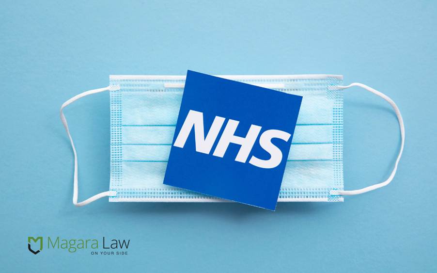 The NHS logo on top of a face mask.