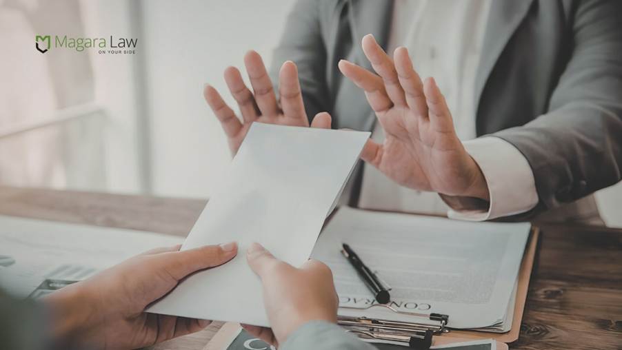 An employee refusing to agree to the terms of a settlement agreement.