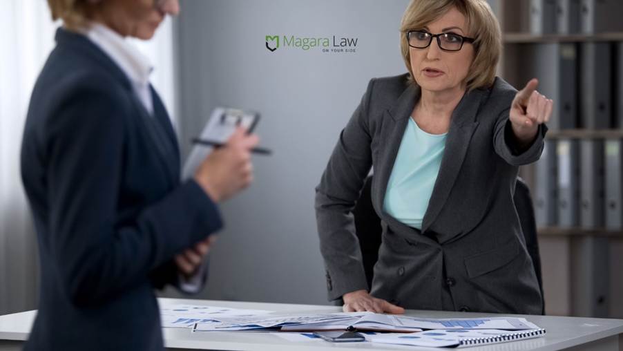 A female employer dismissing a female employee in a seemingly aggressive manner.