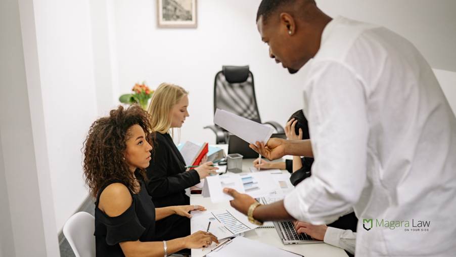 A male boss seemingly intimidating a female employee in a way that could be seen as micro-bullying.