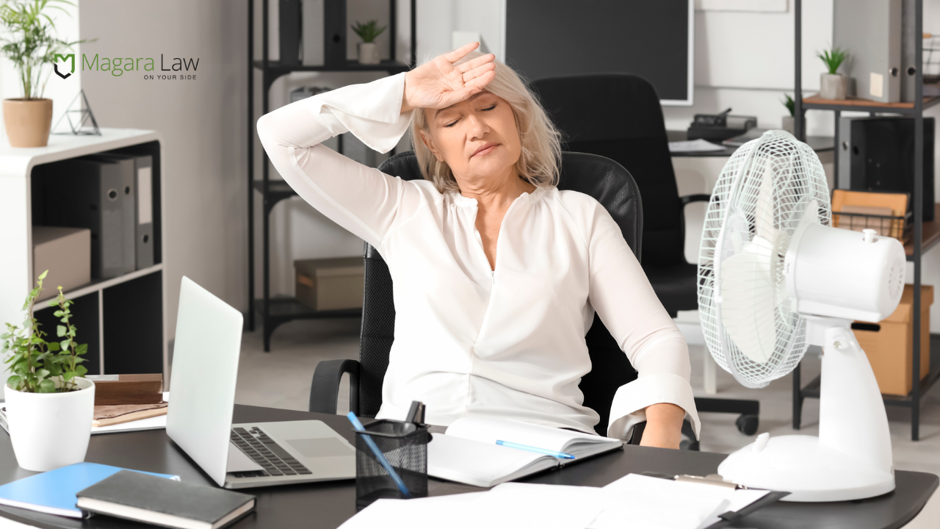 A woman struggling with menopause amid extreme heat at work.